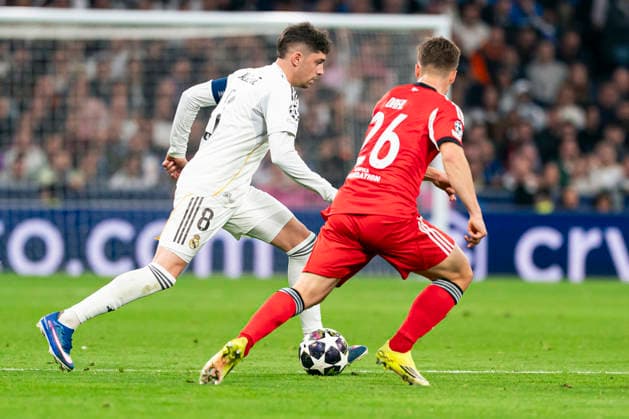 Real Madrid CF s Federico Valverde (l) and SL Benfica s Samuel Dahl during Champions League 2025 2026, KO Play-Offs 2nd leg match. February 25, 2026. (2026022554)
