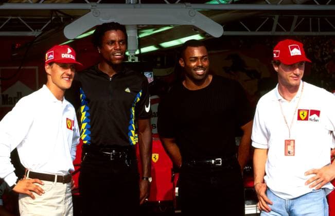 Ferrari team mates Michael Schumacher (GER), left, and Eddie Irvine (GBR), right, stand with Olympic athletics legend Carl Lewis (USA), centre left, and former 100m world record holder Leroy Burrell (USA), centre right. who were guests of Nike...Formula One World Championship, WM, Weltmeisterschaft Rd 12, Belgian Grand Prix, Spa Francorchamps, Belgium, 24 August 1997...BEST IMAGE. Copyright: xSuttonxMotorsportsx