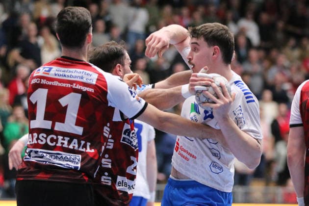 25 02 2026 Handball Men 2025 2026 2 Handball Bundesliga 21 Matchday HSG Nordhorn Lingen Dessau Roßlauer HV 06 EmslandArena Lingen Marcel Nowak Dessau, 15, white in duel with Björn Zintel Nordhorn, 23, red and Tarek Marschall Nordhorn, 11, red Lingen Ems Lower Saxony Germany