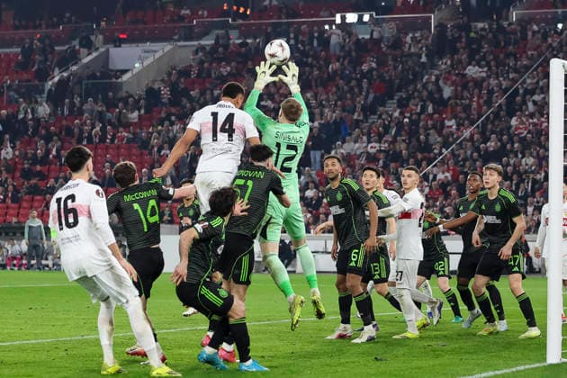 IViljami Sinisalo Celtic Glasgow, 12 catches the ball in front of Luca Jaquez VfB Stuttgart, 14 , Germany, Football, UEFA Europa League, Play offs, 2025 2026, VfB Stuttgart vs Celtic Glasgow, 26 02 2026, Stuttgart MHP Arena Germany Copyright: xGrantxHubbsx