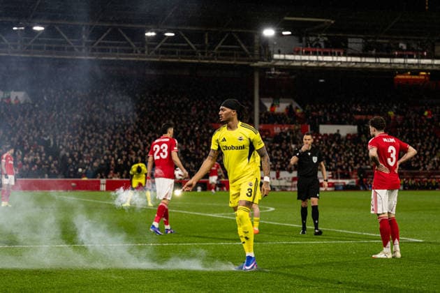 26th February 2026; The City Ground, Nottingham, England; UEFA Europa League Football, Nottingham Forest versus Fenerbahce; Archie Brown of Fenerbahce SK clears a flare off the pitch  GodfreyxPitt Content restricted for UK based newspaper