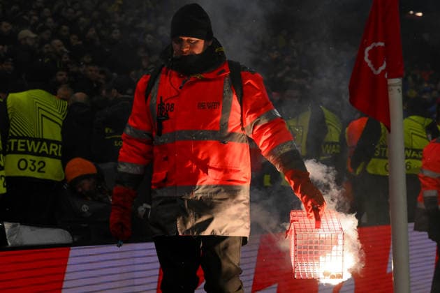 Nottingham Forest FC v Fenerbahce SK - UEFA Europa League 2025 26 Knockout Play-off Second Leg A safety steward carries away a flare during the UEFA Europa League Knockout Round Play-off 2nd Leg between Nottingham Forest and Fenerbahce SK at the City Ground in Nottingham, on February 26, 2026. Nottingham Nottinghamshire United Kingdom  Copyright: xMIxNewsx originalFilename:fletcher-nottingh260226_npr4W.jpg