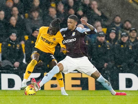 Wolverhampton, England, 27th February 2026. Jackson Tchatchoua of Wolverhampton Wanderers (l) tackled by Ezri Konsa of Aston Villa (r) during the Wolverhampton Wanderers vs Aston Villa Premier League match at Molineux, Wolverhampton. Picture credit should read: Andrew Yates Sportimage EDITORIAL USE ONLY. No use with unauthorised audio, video, data, fixture lists, club league logos or live services. Online in-match use limited to 120 images, no video emulation. No use in betting, games or single club league player publications. SPI_022_AY_Wolves_Villa SPI-4564-0022