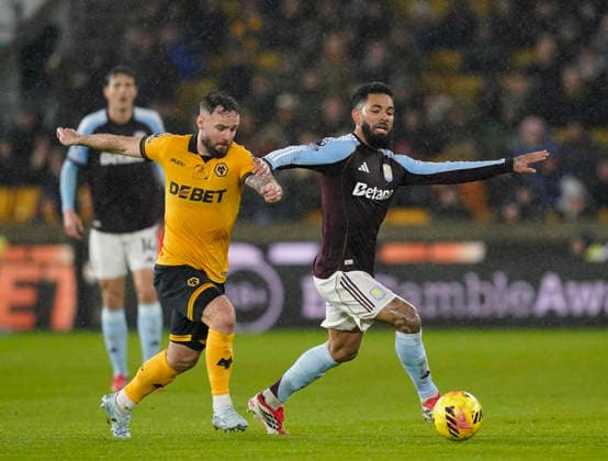 Wolverhampton, England, 27th February 2026. Douglas Luiz of Aston Villa (r) tussles with Adam Armstrong of Wolverhampton Wanderers (l) during the Wolverhampton Wanderers vs Aston Villa Premier League match at Molineux, Wolverhampton. Picture credit should read: Andrew Yates Sportimage EDITORIAL USE ONLY. No use with unauthorised audio, video, data, fixture lists, club league logos or live services. Online in-match use limited to 120 images, no video emulation. No use in betting, games or single club league player publications. SPI_028_AY_Wolves_Villa SPI-4564-0028