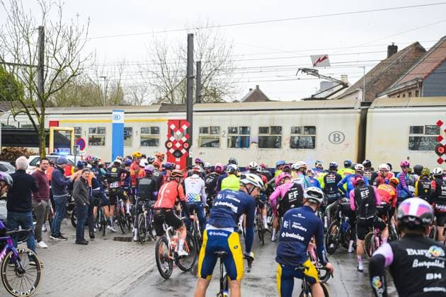 The peloton comes to a stop at a railway crossing during the 81st edition of the men s one-day cycling race Omloop Het Nieuwsblad (UCI World Tour), the opening race of the Flemish one-day classics season, 207,6 km from Gent to Ninove, Saturday 28 February 2026. DAVIDxPINTENS  x165911037x
