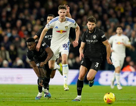 Leeds, England, 28th February 2026. Anton Stach of Leeds United (c) pushes past Marc Guehi of Manchester City (l) and Ruben Dias of Manchester City (r) during the Leeds United vs Manchester City Premier League match at Elland Road, Leeds. Picture credit should read: Andrew Yates Sportimage EDITORIAL USE ONLY. No use with unauthorised audio, video, data, fixture lists, club league logos or live services. Online in-match use limited to 120 images, no video emulation. No use in betting, games or single club league player publications. SPI_056_AY_Leeds_Man_City SPI-4565-0055