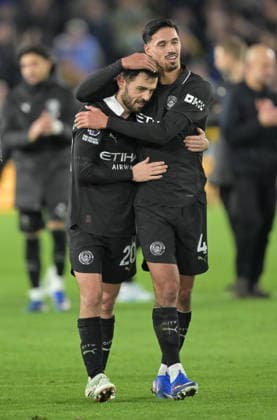 Bernardo Silva and Tijjani Reijnders of Manchester City celebrate at the end of the game Leeds United v Manchester City, Premier League, Football, Elland Road, Leeds, UK - 28 Feb 2026Leeds Elland Road United Kingdom EDITORIAL USE ONLY No use with unauthorised audio, video, data, fixture lists, club league logos or live services. Online in-match use limited to 120 images, no video emulation. No use in betting, games or single club league player publications. Copyright: xGreigxCowie Shutterstockx 16708637aw