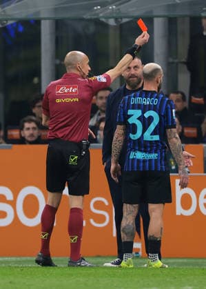 Milan, Italy, 28th February 2026. Daniele De Rossi Head coach of Genoa CFC and Federico Dimarco of FC Internazionale look on as the Referee Michael Fabbri shows a red card to a memeber of the Genoa staff during the Internazionale vs Genoa Serie A match at Giuseppe Meazza, Milan. Picture credit should read: Jonathan Moscrop Sportimage EDITORIAL USE ONLY. No use with unauthorised audio, video, data, fixture lists, club league logos or live services. Online in-match use limited to 120 images, no video emulation. No use in betting, games or single club league player publications. SPI_041_INTER_GENOA_ SPI-4553-0041