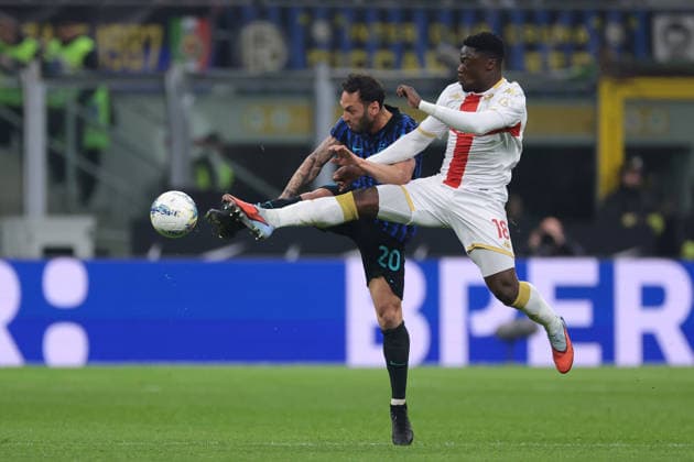 Milan, Italy, 28th February 2026. Caleb Ekuban of Genoa CFC anticipates Hakan Calhanoglu of FC Internazionale to the ball only to be fouled by the Turkish midfielder during the Internazionale vs Genoa Serie A match at Giuseppe Meazza, Milan. Picture credit should read: Jonathan Moscrop Sportimage EDITORIAL USE ONLY. No use with unauthorised audio, video, data, fixture lists, club league logos or live services. Online in-match use limited to 120 images, no video emulation. No use in betting, games or single club league player publications. SPI_069_INTER_GENOA_ SPI-4553-0069