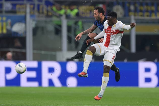Milan, Italy, 28th February 2026. Caleb Ekuban of Genoa CFC anticipates Hakan Calhanoglu of FC Internazionale to the ball only to be fouled by the Turkish midfielder during the Internazionale vs Genoa Serie A match at Giuseppe Meazza, Milan. Picture credit should read: Jonathan Moscrop Sportimage EDITORIAL USE ONLY. No use with unauthorised audio, video, data, fixture lists, club league logos or live services. Online in-match use limited to 120 images, no video emulation. No use in betting, games or single club league player publications. SPI_070_INTER_GENOA_ SPI-4553-0070