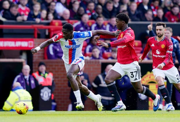Manchester, England, 1st March 2026. Ismaila Sarr of Crystal Palace and Kobbie Mainoo of Manchester United, ManU during the Manchester United vs Crystal Palace Premier League match at Old Trafford, Manchester. Picture credit should read: Andrew Yates Sportimage EDITORIAL USE ONLY. No use with unauthorised audio, video, data, fixture lists, club league logos or live services. Online in-match use limited to 120 images, no video emulation. No use in betting, games or single club league player publications. SPI_026_AY_Man_Utd_Palace SPI-4566-0026