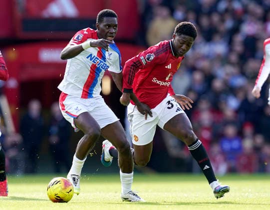 Manchester, England, 1st March 2026. Ismaila Sarr of Crystal Palace tussles with Kobbie Mainoo of Manchester United, ManU during the Manchester United vs Crystal Palace Premier League match at Old Trafford, Manchester. Picture credit should read: Andrew Yates Sportimage EDITORIAL USE ONLY. No use with unauthorised audio, video, data, fixture lists, club league logos or live services. Online in-match use limited to 120 images, no video emulation. No use in betting, games or single club league player publications. SPI_032_AY_Man_Utd_Palace SPI-4566-0032