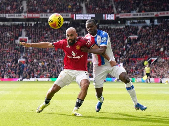 Manchester, England, 1st March 2026. Bryan Mbeumo of Manchester United, ManU tussles with Tyrick Mitchell of Crystal Palace during the Manchester United vs Crystal Palace Premier League match at Old Trafford, Manchester. Picture credit should read: Andrew Yates Sportimage EDITORIAL USE ONLY. No use with unauthorised audio, video, data, fixture lists, club league logos or live services. Online in-match use limited to 120 images, no video emulation. No use in betting, games or single club league player publications. SPI_035_AY_Man_Utd_Palace SPI-4566-0035