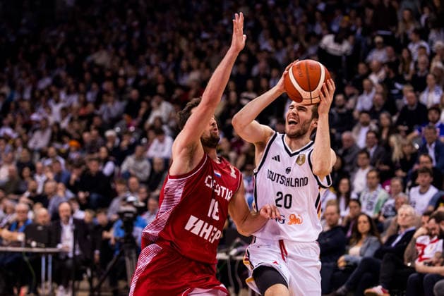 BONN, GERMANY - MARCH 01: Malte Delow (Germany, 20) controls the ball against Roko Badzim (Croatia, 18) during the FIBA World Cup Qualifier match between Germany vs. Croatia at Telekom Dome Bonn on the first round of group E of the FIBA World Cup Qualifiers on March 01, 2026 in Bonn, Germany. North Rhine Westphalia Germany Copyright: xSteffiexWunderlx