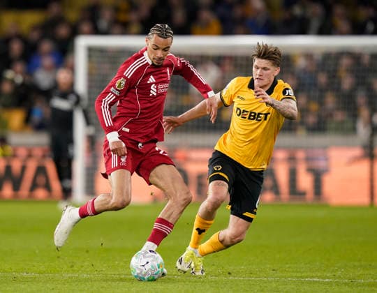Wolverhampton, England, 3rd March 2026. Hugo Ekitike of Liverpool and David Moller Wolfe of Wolverhampton Wanderers during the Wolverhampton Wanderers vs Liverpool Premier League match at Molineux, Wolverhampton. Picture credit should read: Andrew Yates Sportimage EDITORIAL USE ONLY. No use with unauthorised audio, video, data, fixture lists, club league logos or live services. Online in-match use limited to 120 images, no video emulation. No use in betting, games or single club league player publications. SPI_054_AY_Wolves_Liverpool SPI-4574-0051