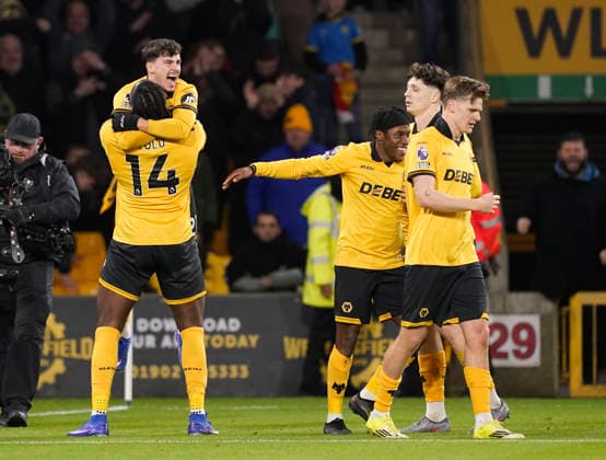 Wolverhampton, England, 3rd March 2026. Rodrigo Gomes of Wolverhampton Wanderers is lifted up to celebrate scoring the first goal during the Wolverhampton Wanderers vs Liverpool Premier League match at Molineux, Wolverhampton. Picture credit should read: Andrew Yates Sportimage EDITORIAL USE ONLY. No use with unauthorised audio, video, data, fixture lists, club league logos or live services. Online in-match use limited to 120 images, no video emulation. No use in betting, games or single club league player publications. SPI_065_AY_Wolves_Liverpool SPI-4574-0061