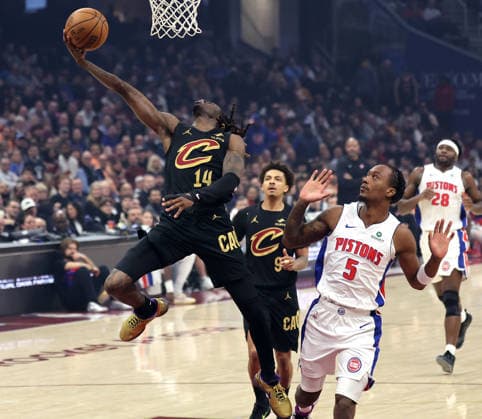 Cleveland Cavalier s Keon Ellis (14) lays the ball in past Detroit Piston s Ron Holland II (5) in the first quarter in Cleveland, Ohio Tuesday March 3, 2026. The Cavaliers defeated the Pistons 113-109.  CLE20260303103 AARONxJOSEFCZYK