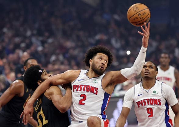 Detroit Piston s Cade Cunningham (2) grabs a rebound over Cleveland Cavalier s Jarrett Allen (31) in the first quarter in Cleveland, Ohio Tuesday March 3, 2026. The Cavaliers defeated the Pistons 113-109.  CLE20260303101 AARONxJOSEFCZYK