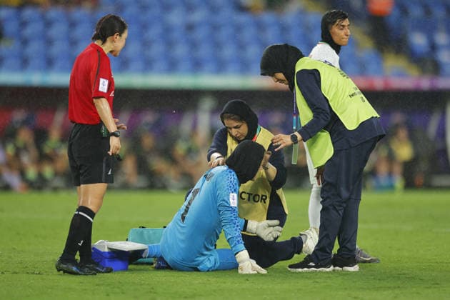 GOLD COAST, AUSTRALIA - MARCH 05 Goalkeeper Raha Yazdani (1 IR Iran) receives medical treatment after injury while match official Asaka Koizumi stands by during the Womens Asian Cup match between Islamic Republic of Iran and Australia at the Gold Coast Stadium on March 05 2026 in Gold Coast, Australia Copyright: xMatthewxStarlingx xSPPx Sportspressphoto_SPR102863