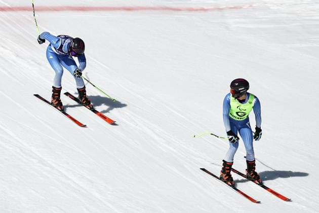 ITALY, VENETO - MARCH 7, 2026: Giacomo Bertagnolli (L) of Italy and his guide Andrea Ravelli compete in the men s downhill skiing event for visually impaired athletes during the 2026 Winter Paralympic Games on the Olympia delle Tofane of the Tofane Alpine Skiing Centre in Cortina d Ampezzo, Province of Belluno. Mikhail Tereshchenko TASS  89692820
