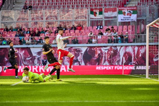 07 03 2026, Football, Men, Bundesliga, 2025 2026, RB Leipzig FC Augsburg Romulo 40, RB Leipzig , jumps over Finn Dahmen 1, FC Augsburg Attempt at goal Leipzig Red Bull Arena Saxony Germany