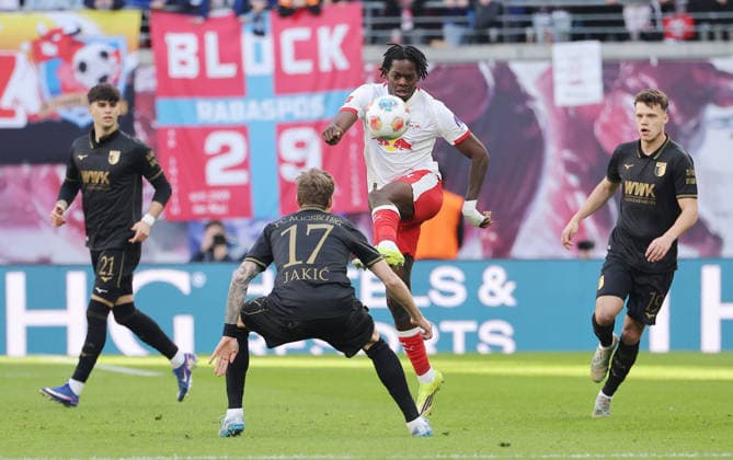 Kristijan Jakic, Castello Lukeba on the ball duel Match scene Action Sport Football Soccer DFL Bundesliga Men 25 Matchday Season 2025 2026 07 03 2026 RasenBallsport RB Leipzig RBL vs FC Augsburg FCA at RedBull Arena DFL regulations prohibit any use of photographs as image sequences and or quasi video
