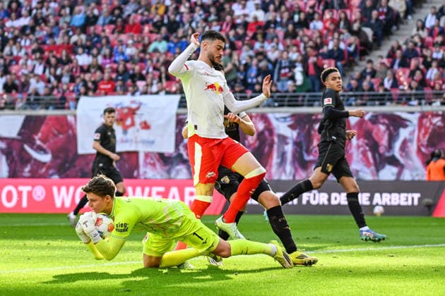 Soccer I Men I Season 2025 2026 I Bundesliga I Matchday 25 I RB Leipzig FC Augsburg I 07 03 2026 One-on-one Finn Dahmen 1, FC Augsburg secures the ball from Romulo Cardoso 40, RB Leipzig , who has to jump over him Leipzig Red Bull Arena Saxony Germany Copyright: xLobeca InesxHähnelx