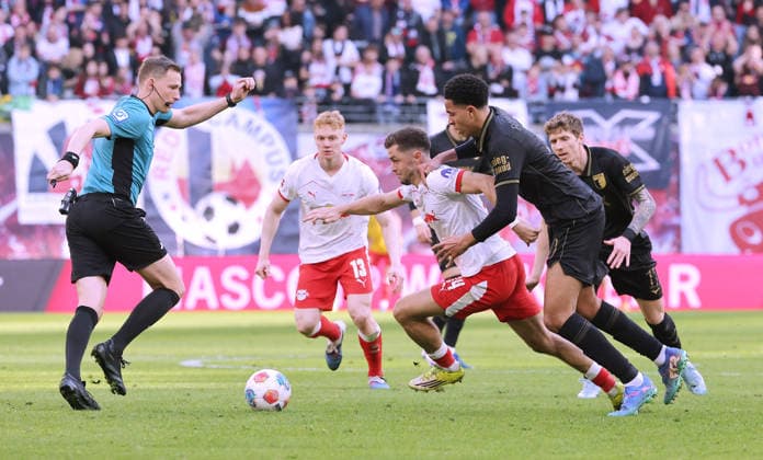 Referee Eleni Antoniou, Christoph Baumgartner on the ball, Noahkai Banks duel Match scene Action Sport Soccer Football DFL Bundesliga Men 25 Matchday Season 2025 2026 07 03 2026 RasenBallsport RB Leipzig RBL vs FC Augsburg FCA at RedBull Arena DFL regulations prohibit any use of photographs as image sequences and or quasi video