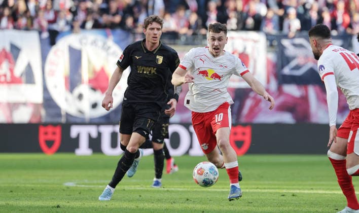 Kristijan Jakic, Brajan Gruda on the ball duel match scene action sport football soccer DFL Bundesliga men 25 matchday season 2025 2026 07 03 2026 RasenBallsport RB Leipzig RBL vs FC Augsburg FCA in the RedBull Arena DFL regulations prohibit any use of photographs as image sequences and or quasi video