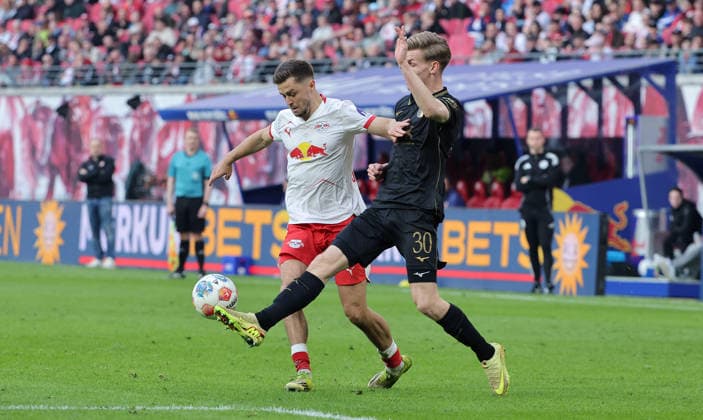 Christoph Baumgartner on the ball, Anton Kade duel Match scene Action Sport Football Soccer DFL Bundesliga Men 25 Matchday Season 2025 2026 07 03 2026 RasenBallsport RB Leipzig RBL vs FC Augsburg FCA in the RedBull Arena DFL regulations prohibit any use of photographs as image sequences and or quasi video