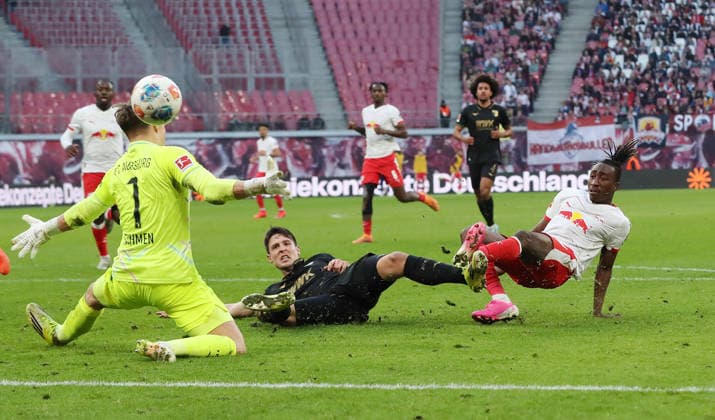 Yan Diomande scores the goal to equalize 1 1 against goalkeeper Finn Dahmen duel Match scene Action Sport Soccer Football DFL Bundesliga Men 25 Matchday Season 2025 2026 07 03 2026 RasenBallsport RB Leipzig RBL vs FC Augsburg FCA at RedBull Arena DFL regulations prohibit any use of photographs as image sequences and or quasi video