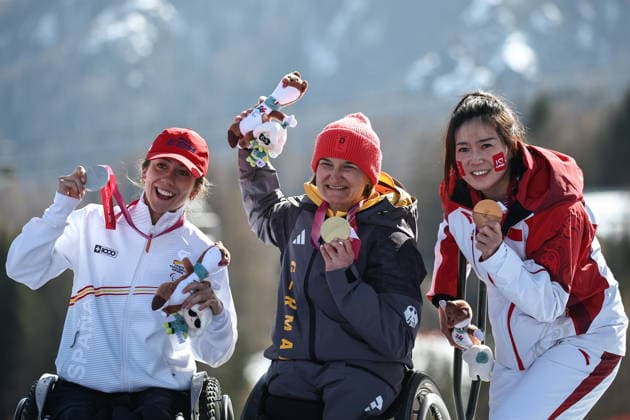 ITALY, VENETO - MARCH 7, 2026: Silver medallist Audrey Pascual Seco of Spain, gold medal winner Anna-Lena Forster and bronze medallist Sitong Liu of China (L-R) celebrate during the victory ceremony for the women s para alpine skiing downhill sit-skiing event at the 2026 Winter Paralympic Games on the Olympia delle Tofane of the Tofane Alpine Skiing Centre in Cortina d Ampezzo, Province of Belluno. Mikhail Tereshchenko TASS  89702952