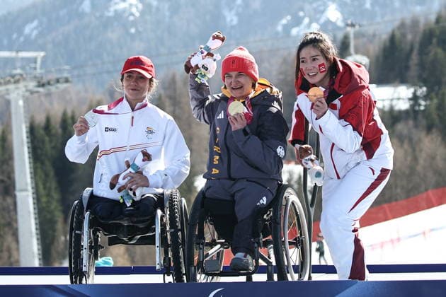 ITALY, VENETO - MARCH 7, 2026: Silver medallist Audrey Pascual Seco of Spain, gold medal winner Anna-Lena Forster and bronze medallist Sitong Liu of China (L-R) celebrate during the victory ceremony for the women s para alpine skiing downhill sit-skiing event at the 2026 Winter Paralympic Games on the Olympia delle Tofane of the Tofane Alpine Skiing Centre in Cortina d Ampezzo, Province of Belluno 2026 Winter Paralympics: Para-Alpine Skiing  - ZUMAt113 20260307_zaa_t113_558 Copyright: xMikhailxTereshchenkox