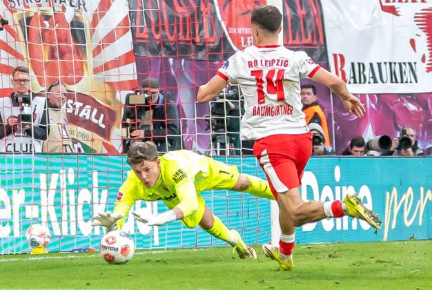 Leipzig, Germany 07 March 2026 1 Bundesliga 2025 2026 RB Leipzig vs FC Augsburg In the picture from left in a duel goalkeeper Finn Dahmen FCA and Christoph Baumgartner RB DFL regulations prohibit any use of photographs as image sequences and or quasi video Copyright: xFotostandx xNachtigallx