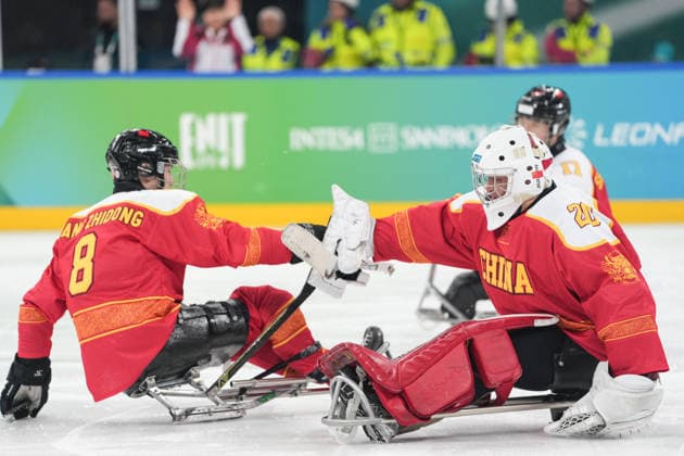 (260308) -- MILAN, March 8, 2026 -- China s Wang Zhidong (L) and Ji Yanzhao celebrate a goal during the Para Ice hockey, Eishockey preliminary round Group A match between China and Germany at the Milan-Cortina 2026 Paralympic Winter games, Winterspiele,Spiele, Summer games in Milan, Italy, March 7, 2026. ) (SP)ITALY-MILAN-PARALYMPIC WINTER GAMES-PARA ICE HOCKEY-CHINA VS GERMANY LixJing 