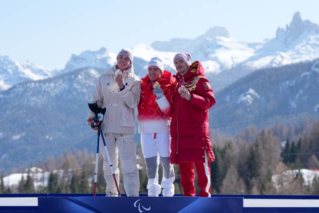 (260308) -- CORTINA D AMPEZZO, March 8, 2026 -- Gold medalist Robin Cuche (C) of Switzerland, silver medalist Arthur Bauchet (L) of France, bronze medalist Aleksei Bugaev of Russia react during the awarding ceremony for the para alpine skiing men s downhill standing match at the Milan-Cortina 2026 Paralympic Winter games, Winterspiele,Spiele, Summer games in Cortina D ampezzo, Italy, March 7, 2026. ) (SP)ITALY-CORTINA D AMPEZZO-PARALYMPIC WINTER GAMES-PARA ALPINE SKIING-MEN S DOWNHILL-STANDING WangxKaiyan 