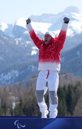 (260308) -- CORTINA D AMPEZZO, March 8, 2026 -- Gold medalist Robin Cuche of Switzerland reacts during the awarding ceremony for the para alpine skiing men s downhill standing match at the Milan-Cortina 2026 Paralympic Winter games, Winterspiele,Spiele, Summer games in Cortina D ampezzo, Italy, March 7, 2026. ) (SP)ITALY-CORTINA D AMPEZZO-PARALYMPIC WINTER GAMES-PARA ALPINE SKIING-MEN S DOWNHILL-STANDING WangxKaiyan 