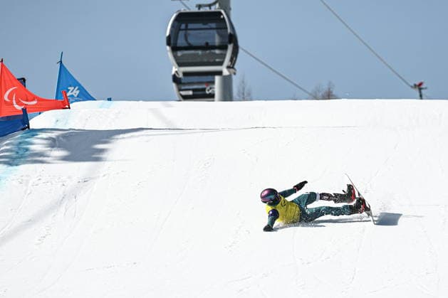 ITALY, VENETO - MARCH 8, 2026: Filipp Shebbo of Russia loses balance during the men s para snowboard snowboard cross SB-LL1 event at Cortina Para Snowboard Park during the 2026 Winter Paralympic Games. Mikhail Tereshchenko TASS  89754076