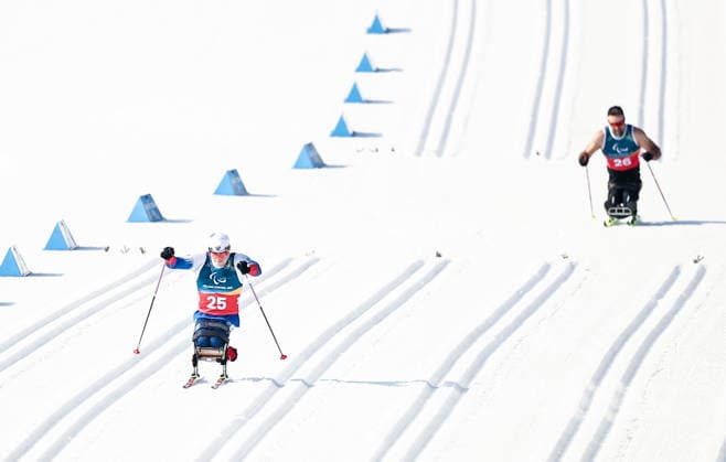ITALY, TESERO - MARCH 10, 2026: Ivan Golubkov (L) of Russia and Collin Cameron of Canada compete in a men s para cross-country skiing sitting sprint at Tesero Cross-Country Stadium during the 2026 Winter Paralympic Games. Mikhail Tereshchenko TASS  89842290