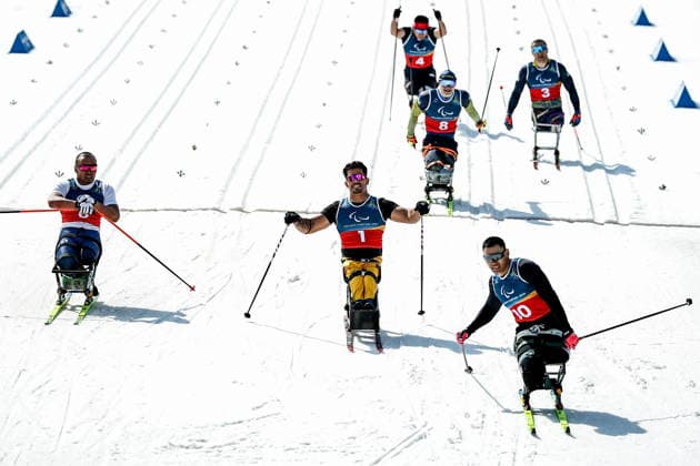 ITALY, TESERO - MARCH 10, 2026: Zixu Liu of China, Cristian Westemaier Ribera of Brazil, and Yerbol Khamitov (L-R) of Kazakhstan finish a men s para cross-country skiing sitting sprint final at Tesero Cross-Country Stadium during the 2026 Winter Paralympic Games. Vladimir Tyorkin TASS  89847464