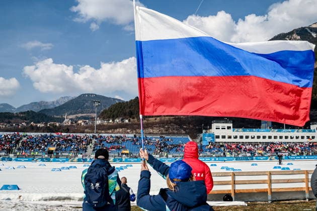 ITALY, TESERO - MARCH 10, 2026: A fan carries the Russian flag during a women s para cross-country skiing classic vision impaired sprint semifinal at Tesero Cross-Country Stadium during the 2026 Winter Paralympic Games 2026 Winter Paralympics: Para Cross-Country Skiing  - ZUMAt113 20260310_zaa_t113_143 Copyright: xMikhailxTereshchenkox