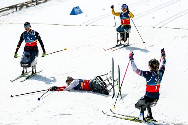 ITALY, TESERO - MARCH 10, 2026: Wang of China, Oksana Masters of the USA, and Aline dos Santos Rocha of Brazil finish a women s para cross-country skiing sitting sprint final at Tesero Cross-Country Stadium during the 2026 Winter Paralympic Games. Mikhail Tereshchenko TASS  89847385