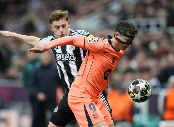 Newcastle Upon Tyne, England, 10th March 2026. Harvey Barnes of Newcastle United (l) tussles with Robert Lewandowski of FC Barcelona, Barca during the Newcastle United vs FC Barcelona UEFA Champions League match at St. James Park, Newcastle Upon Tyne. Picture credit should read: Nigel Roddis Sportimage EDITORIAL USE ONLY. No use with unauthorised audio, video, data, fixture lists, club league logos or live services. Online in-match use limited to 120 images, no video emulation. No use in betting, games or single club league player publications. SPI_038_NR_NEWC_BARCx SPI-4596-0038