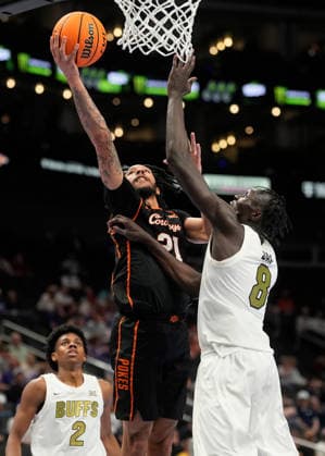 MAR 10 2026: Oklahoma State Cowboys guard Isaiah Coleman (21) gets his shot blocked by Colorado Buffaloes forward Bangot Dak (8) in the Big 12 Championship Tournament at T-Mobile center, Kansas City, Missouri. CSM. Kansas City United States - ZUMAc04_ 20260310_zma_c04_208 Copyright: xJonxRobichaudx