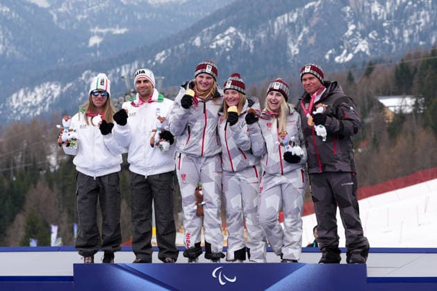 (260311) -- CORTINA D AMPEZZO, March 11, 2026 -- Gold medalist Veronika Aigner (C, L) and her guide Lilly Sammer (C, R) of Austria, silver medalist Chiara Mazzel (1st L) of Italy and her guide Nicola Cotti Cottini (2nd L) and bronze medalist Elina Stary (2nd R) and her guide Stefan Winter (1st R) of Austria pose for photos during the awarding ceremony for the para alpine skiing women s combined vision impaired event at the Milan-Cortina 2026 Paralympic Winter games, Winterspiele,Spiele, Summer games in Cortina D ampezzo, Italy, March 10, 2026. ) (SP)ITALY-CORTINA D AMPEZZO-PARALYMPIC WINTER GAMES-PARA ALPINE SKIING-WOMEN S COMBINED-VISION IMPAIRED LianxYi 