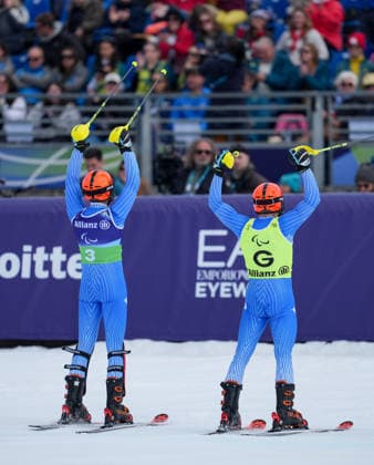 (260311) -- CORTINA D AMPEZZO, March 11, 2026 -- Giacomo Bertagnolli (L) and his guide Andrea Ravelli of Italy celebrate after winning the Para Alpine Skiing Men s Alpine Combined Vision Impaired event at the Milan-Cortina 2026 Paralympic Winter games, Winterspiele,Spiele, Summer games in Cortina D ampezzo, Italy, March 10, 2026. ) (SP)ITALY-CORTINA D AMPEZZO-PARALYMPIC WINTER GAMES-PARA ALPINE SKIING-MEN S ALPINE COMBINED-VISION IMPAIRED WangxKaiyan 