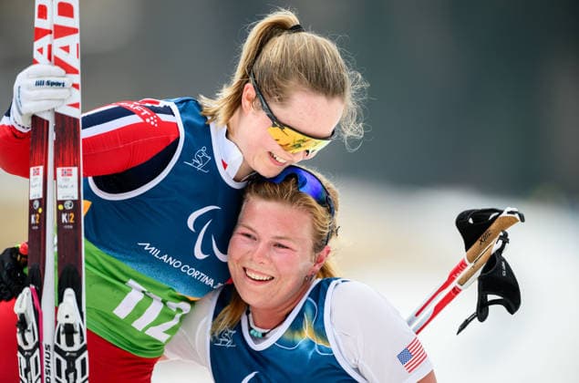 260311 Vilde Nilsen of Norway and Sydney Peterson of USA celebrate after competing in the women s 10km interval start standing para cross-country skiing during day 5 of the Milano Cortina 2026 Winter Paralympic Games on March 11, 2026 in Val di Fiemme. Photo: Maxim Thore BILDBYRAN kod MT MT1019 skidor cross-country skiing langrenn paralympic games paralympics paralympiska spel paralympiske leker vinter-paralympics winter paralympics milano cortina 2026 milano cortina 2026 winter paralympic games 5 bbeng norge *** 260311 Vilde Nilsen of Norway and Sydney Peterson of USA celebrate after competing in the women s 10km interval start standing para cross country skiing during day 5 of the Milano Cortina 2026 Winter Paralympic Games on March 11, 2026 in Val di Fiemme Photo Maxim Thore BILDBYRAN kod MT MT1019 skidor cross country skiing langrenn paralympic games paralympiska spel paralympiske leker vinter paralympics winter paralympics milano cortina 2026 milano cortina 2026 winter paralympic games 5 bbeng norge  Copyright: MAXIMxTHORE BB260311MT045