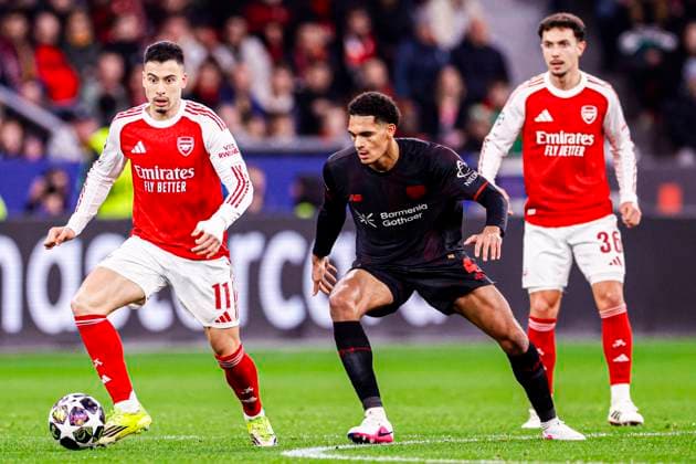 Gabriel Martinelli of Arsenal FC battles for possession with Jarell Quansah of Bayer 04 Leverkusen Bayer 04 Leverkusen v Arsenal FC, UEFA Champions League 2025 26 Round of 16 First Leg, Bayer 04 Leverkusen v Arsenal FC, BayArena, March 11, 2026, Leverkusen, Germany.