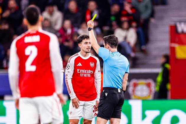 Referee Umut Meler shows a yellow card to Martin Zubimendi of Arsenal FC Bayer 04 Leverkusen v Arsenal FC, UEFA Champions League 2025 26 Round of 16 First Leg, Bayer 04 Leverkusen v Arsenal FC, BayArena, March 11, 2026, Leverkusen, Germany.