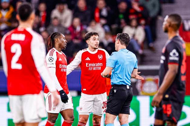 Martin Zubimendi of Arsenal FC and Eberechi Eze of Arsenal FC is in discussion with Referee Umut Meler Bayer 04 Leverkusen v Arsenal FC, UEFA Champions League 2025 26 Round of 16 First Leg, Bayer 04 Leverkusen v Arsenal FC, BayArena, March 11, 2026, Leverkusen, Germany.
